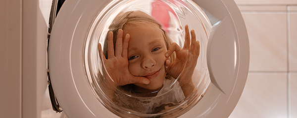 Child playing with washing machine