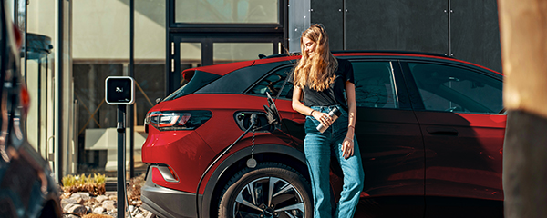 Woman charging her electric vehicle at a charging station