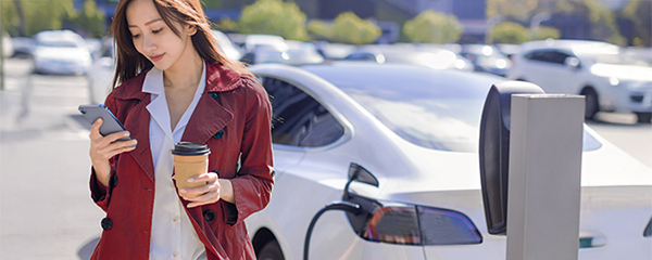 Woman by electric car